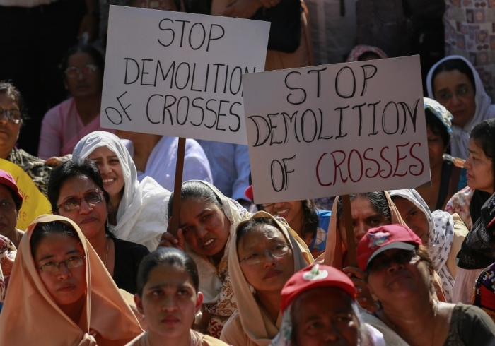 Protesters hold placards during a rally by hundreds of Christians against recent attacks on churches nationwide, in Mumbai, India, February 9, 2015.