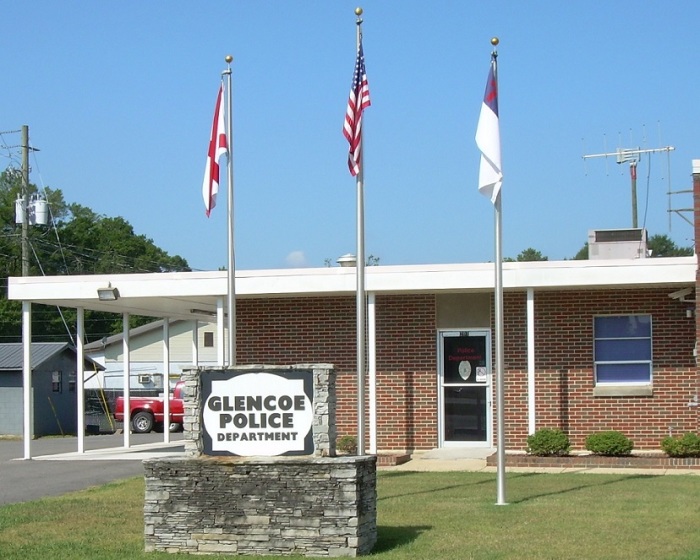 The police department for the City of Glencoe, Alabama. The flag on the right is a Christian flag which was removed in late June 2015 after the Freedom From Religion Foundation sent a letter threatening legal action.