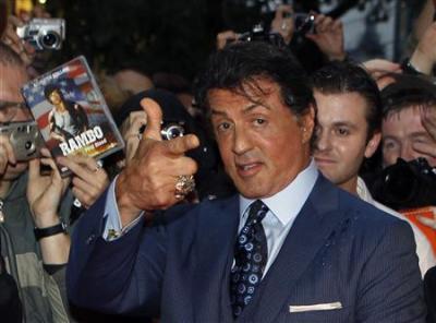 U.S. actor Sylvester Stallone poses with fans as he arrives for the German premiere of his movie ''The Expendables'' in Berlin in this August 6, 2010 file photo.