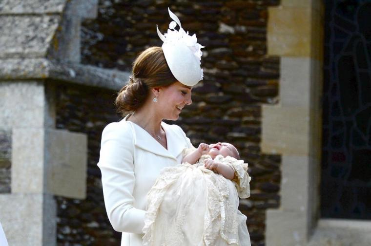 Catherine, the Duchess of Cambridge, carries her daughter Princess Charlotte into the Church of St Mary Magdalene on the Sandringham Estate for the princess's christening July 5, 2015.