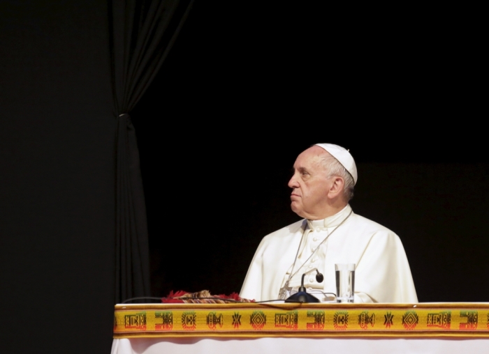 Pope Francis looks to the side as he attends a World Meeting of Popular Movements with Bolivia's President Evo Morales (not pictured) in Santa Cruz, Bolivia, July 9, 2015. Pope Francis on Thursday urged the downtrodden to change the world economic order, denouncing a 'new colonialism' by agencies that impose austerity programs and calling for the poor to have the 'sacred rights' of labor, lodging and land. In one of the longest, most passionate and sweeping speeches of his pontificate, the Argentine-born pope also asked forgiveness for the sins committed by the Roman Catholic Church in its treatment of native Americans during what he called the 'so-called conquest of America.'