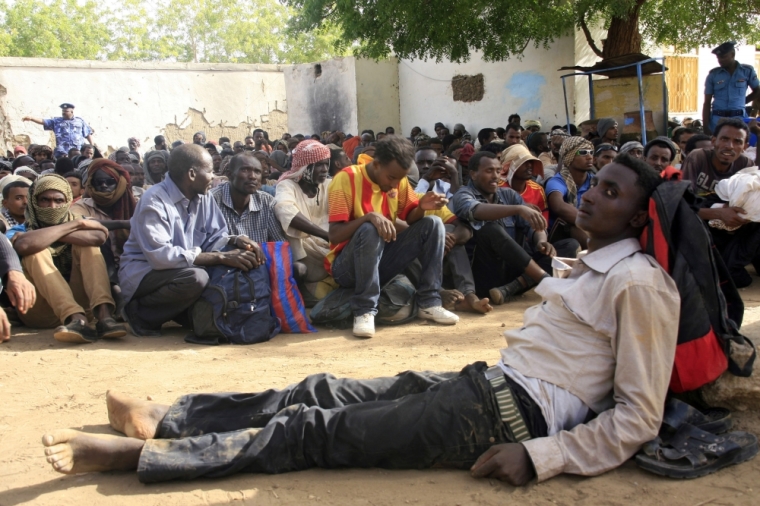 Illegal immigrants who were abandoned by traffickers in a remote desert area wait inside a military base in Dongola town, after being located by Sudanese and Libyan forces, May 3, 2014. The desert area between Sudan and Libya is a major route for illegal immigrants trying to escape Sudan's war-torn regions, with many of them transiting in Libya before trying to flee to Europe across the Mediterranean Sea.