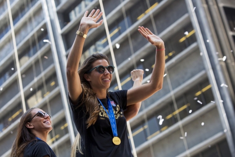 Tobin Heath (C) of the U.S. women's soccer team cheers during the ticker tape parade to celebrate the U.S Team's World Cup final win over Japan on Sunday, in New York, July 10, 2015. Screams and a blizzard of confetti cheered the World Cup winning U.S. women's soccer players as they rolled up New York City's 'Canyon of Heroes' on Friday in the first ticker-tape parade honoring a women's sports team.