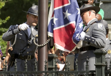 The Confederate battle flag is permanently removed from the South Carolina statehouse grounds during a ceremony in Columbia, South Carolina, July, 10, 2015. South Carolina removed the Confederate battle flag from the state capitol grounds on Friday to chants of "USA, USA!," after three weeks of emotional debate over the banner, a symbol of slavery and racism to many, but of Southern heritage and pride to others.