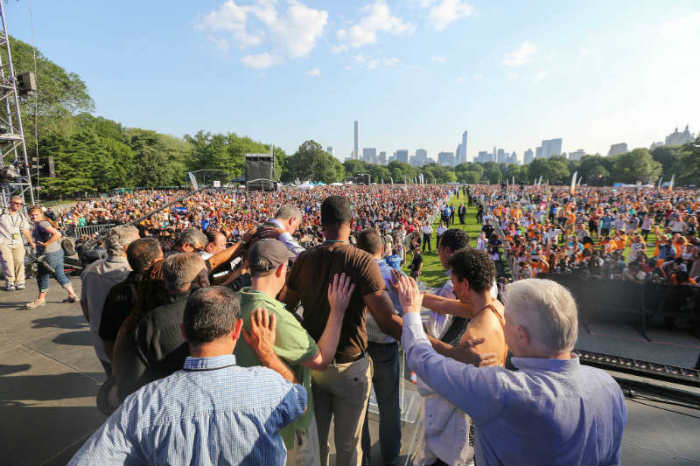 Several local pastors and evangelist Luis Palau lay hands on New York City Mayor Bill de Blasio as they pray for him on stage at the Great Lawn at Central Park on July 11, 2015, in New York City.