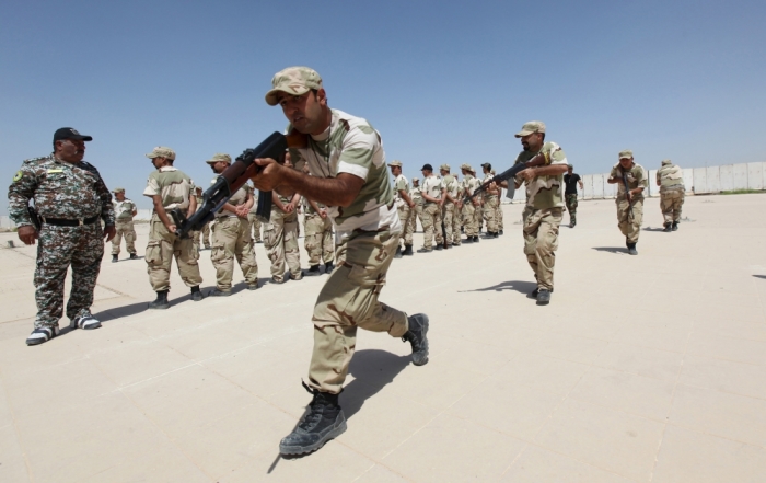 Iraqi Christians volunteers, who have joined Hashid Shaabi (Popular Mobilization), allied with Iraqi forces against the Islamic State, take part in a training at a military camp in Baghdad, July 1, 2015.