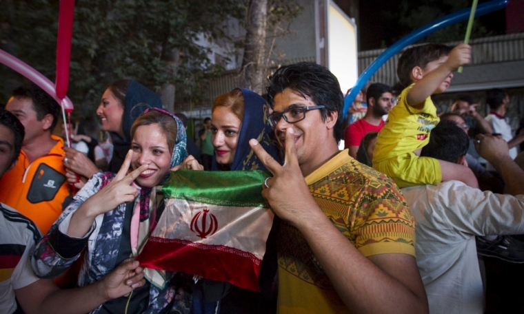 Iranians gesture as they celebrate in the street following a nuclear deal with major powers, in Tehran, July 14, 2015. Iran's president Hassan Rouhani said on Tuesday a nuclear deal with major powers would open a new chapter of cooperation with the outside world after years of sanctions, predicting the 'win-win' result would gradually eliminate mutual mistrust.