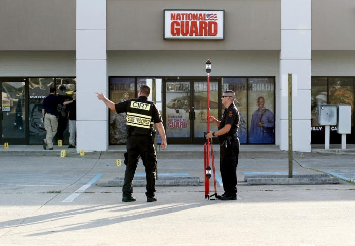 FBI agents and local police work the scene at the Armed Forces Career Center in Chattanooga, Tennessee, July 16, 2015. Four Marines were killed on Thursday by a gunman who opened fire at two military offices in Chattanooga, Tennessee, before being fatally shot in an attack officials called a brazen, brutal act of domestic terrorism.