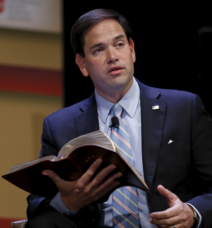 U.S. Republican presidential candidate Sen. Marco Rubio, R-Fla., reads from the Bible at the Family Leadership Summit in Ames, Iowa, United States, July 18, 2015.