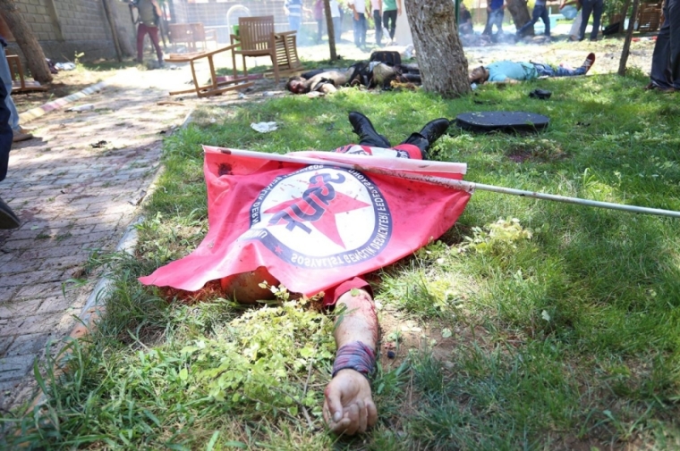 A victim of a bombing in Suruc, Turkey, lies under the flag of the Federation of Socialist Youth Associations on July 20, 2015.