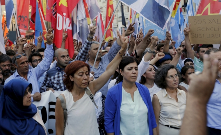 Demonstrators hold a minute of silence for the victims during a protest against the bomb attack in the border town of Suruc, in central Istanbul, Turkey, July 20, 2015. A suspected Islamic State suicide bomber killed at least 28 people, mostly young students, in an attack on a Turkish town near the Syrian border on Monday. Television footage showed bodies lying beneath trees outside a cultural centre in the mostly Kurdish town of Suruc in southeastern Turkey, some 10 km (6 miles) from the Syrian town of Kobani where Kurdish fighters have been battling Islamic State. The blast tore through a group of mostly university-aged students from an activist group as they gathered to make a statement to the local press about a trip they were planning to help rebuild Kobani. The Hurriyet daily said the attacker was an 18-year old woman, but there was no confirmation.