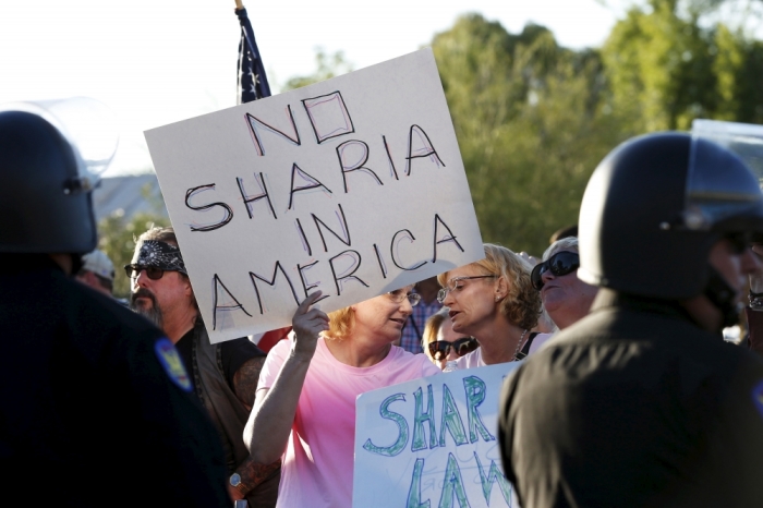 Women attend a 'Freedom of Speech Rally Round II' across the street from the Islamic Community Center in Phoenix, Arizona May 29, 2015. More than 200 protesters, some armed, berated Islam and its Prophet Mohammed outside an Arizona mosque on Friday in a provocative protest that was denounced by counterprotesters shouting 'Go home, Nazis,' weeks after an anti-Muslim event in Texas came under attack by two gunmen.