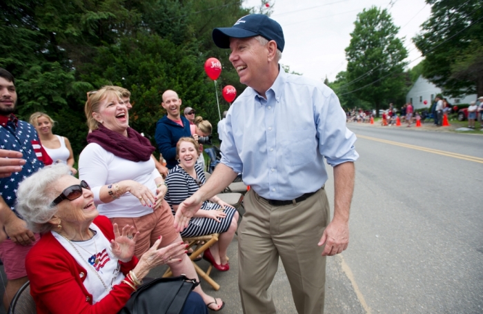 Republican presidential candidate Sen. Lindsey Graham, R-S.C., shakes hands along the Independence Day parade route in Amherst, New Hampshire July 4, 2015. New Hampshire is home of the nation's first presidential nominating primary.