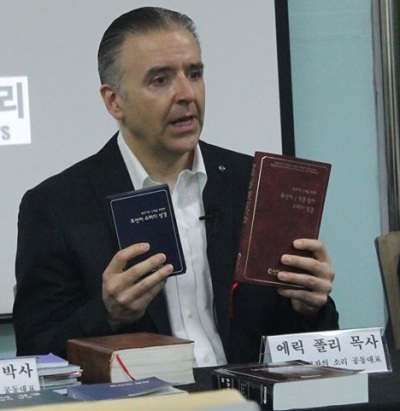 The Reverend Eric Foley, CEO of the Voice of the Martyrs Korea, showcasing biblical materials destined to be sent via balloon into the southern part of North Korea at a press conference in July 2015.