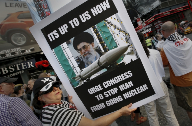 A woman holds a placard as she joins several thousand other protesters to demonstrate during a rally opposing the nuclear deal with Iran in Times Square, July 22, 2015.