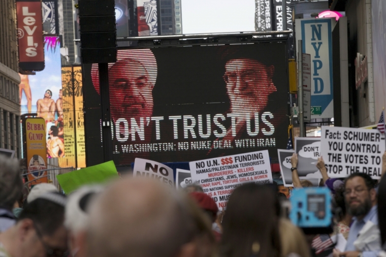 An image of Iranian leaders is projected on a giant screen in front of demonstrators during a rally opposing the nuclear deal with Iran in Times Square, July 22, 2015.