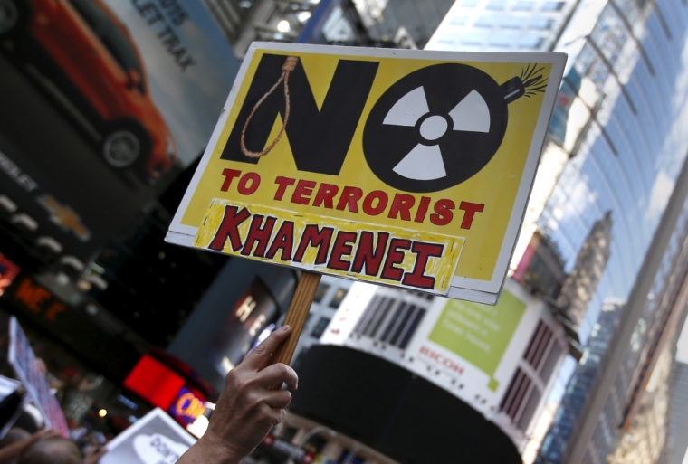 A protestor holds a placard during a demonstration and rally opposing the nuclear deal with Iran in Times Square, July 22, 2015.