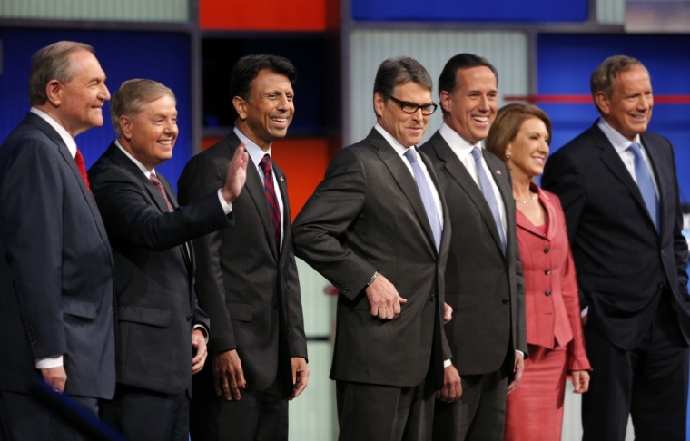 Republican presidential candidates (L-R), former Virginia Governor Jim Gilmore, U.S. Senator Lindsey Graham, Louisiana Governor Bobby Jindal, former Texas Governor Rick Perry, former U.S. Senator Rick Santorum, former HP CEO Carly Fiorina and former New York Governor George Pataki, pose before the start of a Fox-sponsored forum for lower polling candidates held before the first official Republican presidential candidates debate of the 2016 U.S. presidential campaign in Cleveland, Ohio, August 6, 2015.