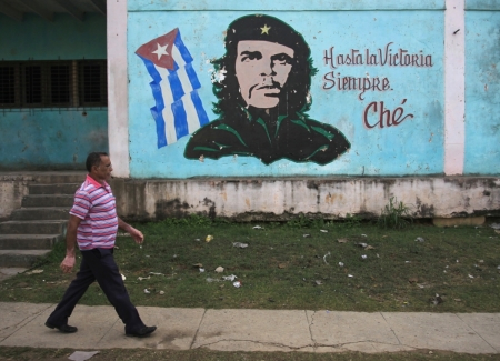 A man walks past near an image of revolutionary hero Ernesto