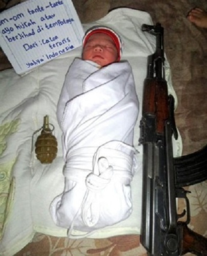 This undated picture of a baby is from the Twitter feed of Indonesian IS follower Abu Karimah. The sign in Indonesian says "Uncles and aunts come and fight in Syria for jihad wherever you are."