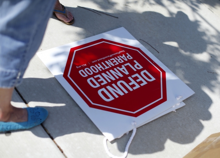 Protesters stand on a sidewalk outside a Planned Parenthood clinic in Vista, California, August 3, 2015.