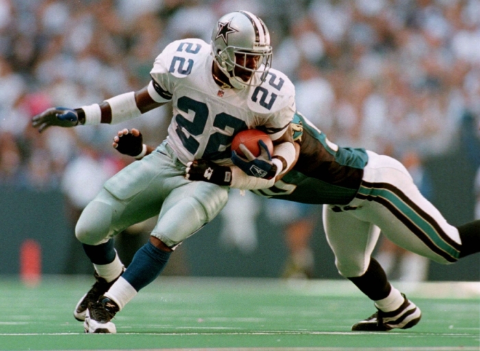 Dallas Cowboys running back Emmit Smith (L) breaking a tackle attempt by Eddie Robinson of the Jacksonville Jaguars during an NFL game on October 19, 1997. Smith put an end to days-old speculation on February 3, 2005, by officially announcing his retirement at an afternoon press conference. Smith, the NFL's all-time leading rusher and a three-time Super Bowl champion with Dallas, made the announcement in the Super Bowl Media Center behind a Cowboys helmet. After spending the past two seasons with the Arizona Cardinals, the 15-year NFL veteran signed a ceremonial contract with the Cowboys so he could retire as a member of the team where he spent his first 13 seasons. Picture taken October 19, 1997.