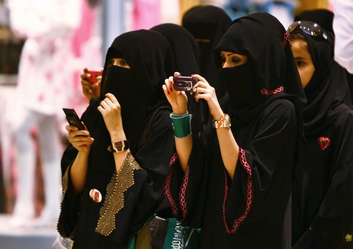Veiled Saudi women take photos of their children during a ceremony to celebrate Saudi Arabia's Independence Day in Riyadh, September 23, 2009.