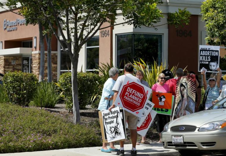 Protesters gather outside a Planned Parenthood clinic in Vista, California August 3, 2015.