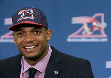 Newly signed defensive end Michael Sam smiles as he is introduced to the media by the Montreal Alouettes CFL football team in Montreal, May 26, 2015.
