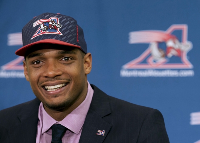 Newly signed defensive end Michael Sam smiles as he is introduced to the media by the Montreal Alouettes CFL football team in Montreal, May 26, 2015.