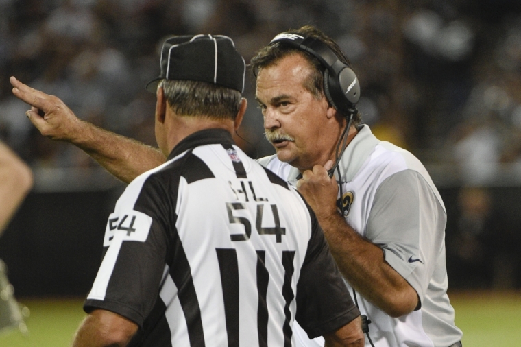 St. Louis Rams head coach Jeff Fisher (R) talks to head linesman George Hayward (54) against the Oakland Raiders during the second quarter in a preseason NFL football game at O.co Coliseum, Oakland, California, August 14, 2015.