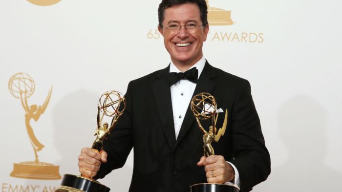 Stephen Colbert poses backstage with his awards for Outstanding Variety Series and Outstanding Writing For A Variety Series at the 65th Primetime Emmy Awards in Los Angeles on Sept. 22, 2013.