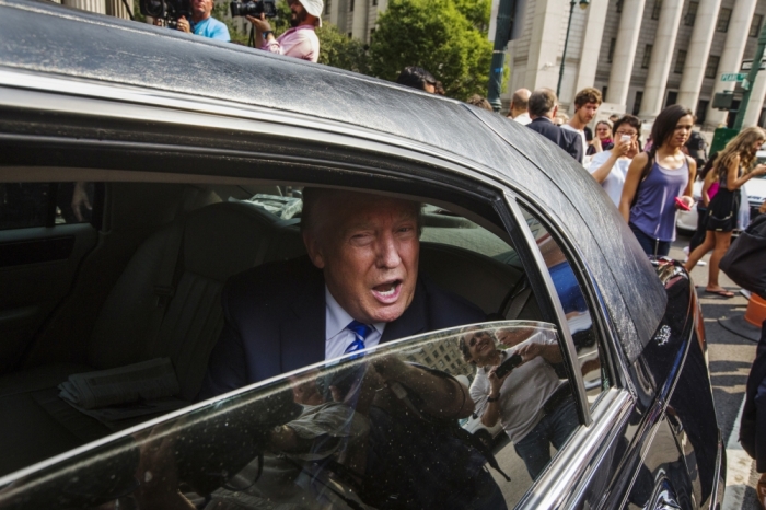 U.S. Republican presidential candidate Donald Trump sits in a limousine as he departs jury duty at Manhattan Supreme Court in New York August 17, 2015. The real estate mogul's jury service came after a state judge earlier this year fined him 0 for failing to respond to summonses to serve jury duty five times since 2006.