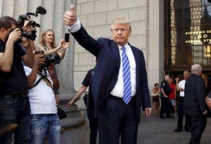 U.S. Republican presidential candidate Donald Trump gestures after arriving for jury duty at Manhattan Supreme Court in New York, August 17, 2015.