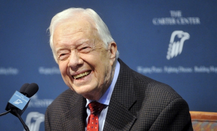 Former U.S. President Jimmy Carter takes questions from the media during a news conference about his recent cancer diagnosis and treatment plans, at the Carter Center in Atlanta, Georgia August 20, 2015. Carter said on Thursday he will start radiation treatment for cancer on his brain later in the day. Carter, 90, said he will cut back dramatically on his schedule to receive treatment every three weeks after doctors detected four spots of melanoma on his brain following recent liver cancer surgery.