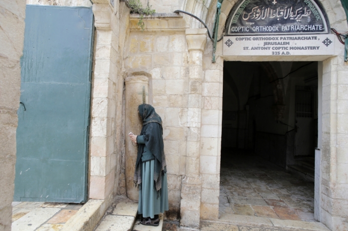 A worshipper prays outside the Coptic Orthodox Patriarchate during a prayer service in Jerusalem's Old City for 21 Egyptians Christians whom Islamic State militants beheaded, according to a video released earlier this week, February 18, 2015. Egypt directly intervened for the first time in the conflict in neighboring Libya on Monday after an Islamic State group in the country released a video showing the beheading of 21 Egyptian Christians.