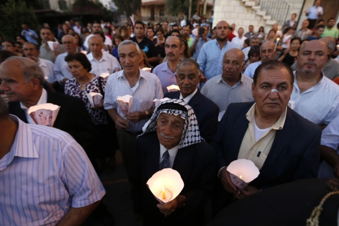 Christians take part in a candlelight march and prayed for peace in Gaza, Jordan, and in the Arab region, at the Greek Orthodox Church, in Al-Fuheis near Amman August 11, 2014. Participants passed by three churches, the Roman Catholic, Greek Orthodox and Latin Churches, which are the three main churches in the area according to the organizers.