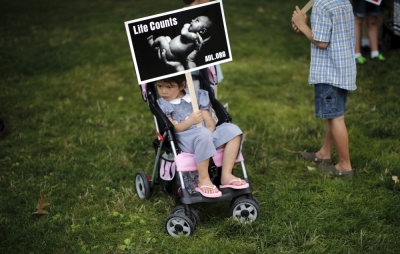 A girl holds a sign as she attends a 'Women Betrayed Rally to Defund Planned Parenthood' at Capitol Hill in Washington, July 28, 2015. 