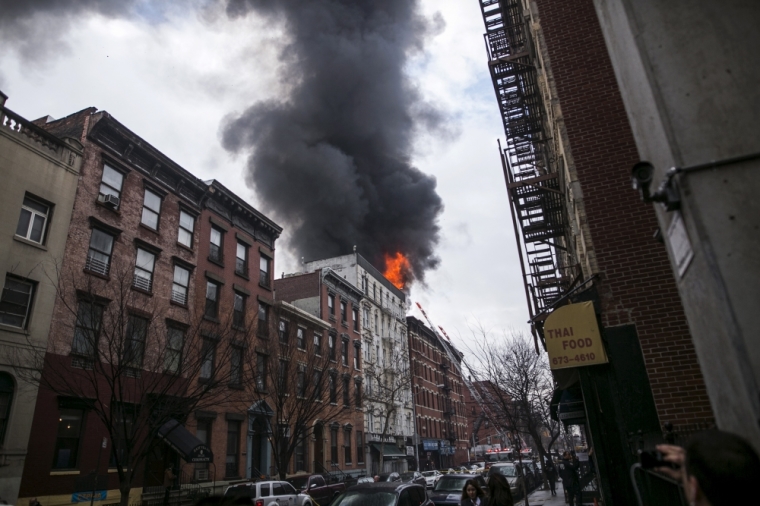 Flames rise from a building fire in the East Village neighborhood of New York City on March 26, 2015. A residential apartment building collapsed and was engulfed in flames on Thursday in New York City's East Village neighborhood, critically injuring at least one person, authorities said.