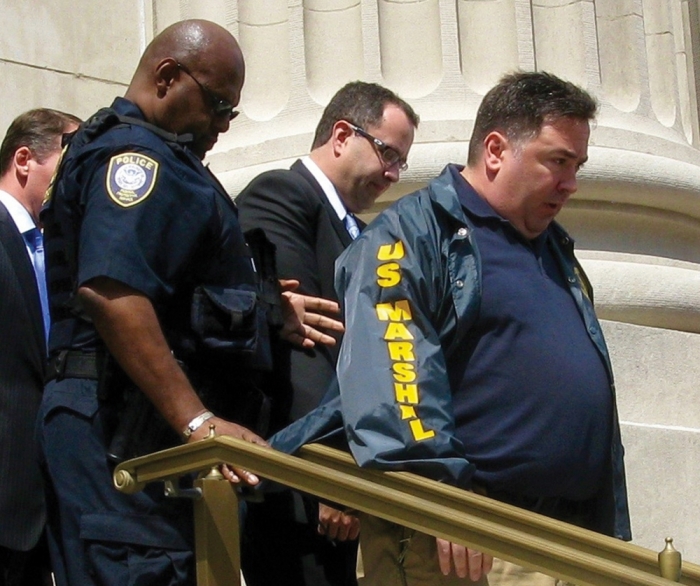 Jared Fogle is led from federal court in Indianapolis, Indiana August 19, 2015. Fogle, the former Subway sandwich chain pitchman asked a federal judge on Wednesday to accept his plea of guilty to charges of child pornography and travelling for illicit paid sex with minors.