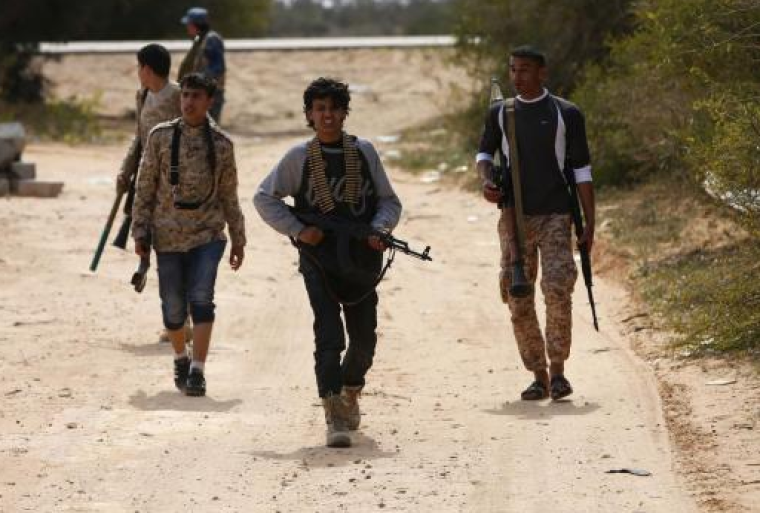 A group of teenage boys move towards Islamic State posts in Sirte, Libya on March 16, 2015