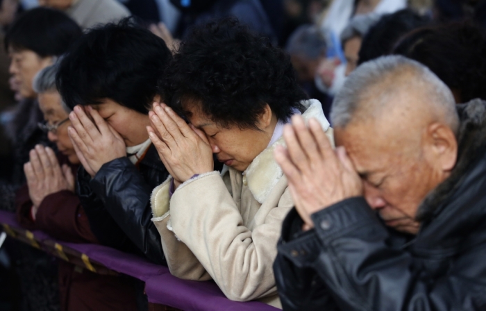 Believers take part in a weekend mass at an underground Catholic church in Tianjin November 10, 2013.