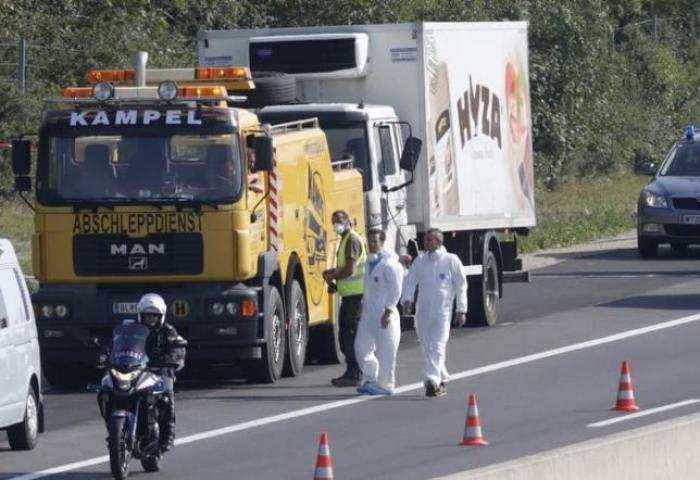 A truck in which 71 migrants were found dead is prepared to be towed away on a motorway near Parndorf, Austria August 27, 2015.