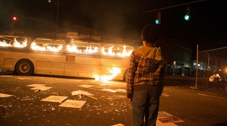 An image from the upcoming film "Woodlawn" that depicts a bus burning during 1970s Alabama.