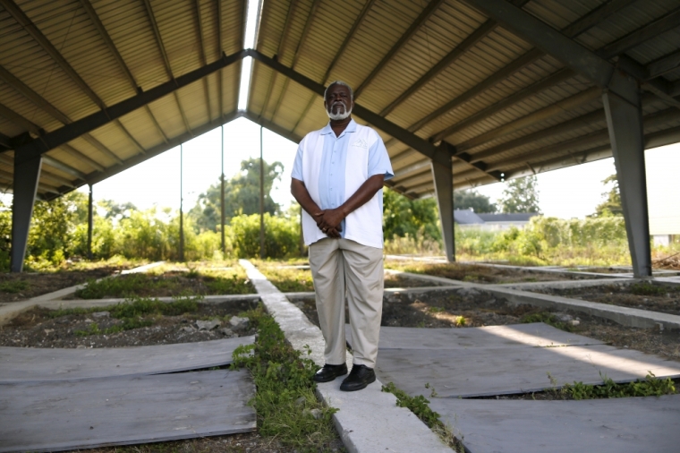 Rev. Charles Duplessis poses for a picture at the construction site of his fellowship's new church, the Mount Nebo Bible Baptist Church, in the Lower Ninth Ward neighborhood of New Orleans, Louisiana, July 31, 2015. The old church was destroyed by Hurricane Katrina. A decade after Hurricane Katrina, New Orleans seems to have found its rhythm again: the French Quarter is choked with tourists, construction cranes tower over the skyline, and hipsters bike to cafes in gentrifying neighborhoods.