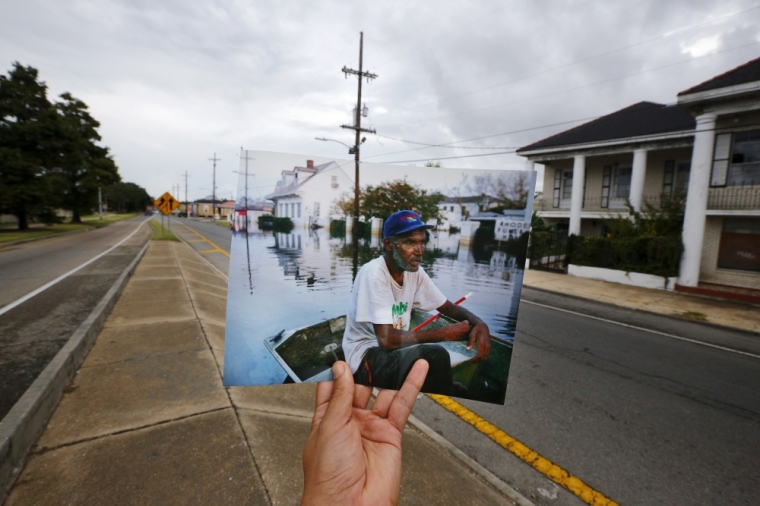 Photographer Carlos Barria holds a print of a photograph he took in 2005, as he matches it up at the same location 10 years on, in New Orleans, United States, August 16, 2015. The print shows Errol Morning sitting on his boat on a flooded street September 5, 2005, after Hurricane Katrina struck. In 2005, Hurricane Katrina triggered floods that inundated New Orleans and killed more than 1,500 people as storm waters overwhelmed levees and broke through floodwalls. Congress authorized spending more than billion to beef up the city's flood protection after Katrina and built a series of new barriers that include man-made islands and new wetlands. After photographing events a decade ago, Reuters photographer Carlos Barria returned to New Orleans. Using photos he took 10 years ago, Barria found the same locations that he documented originally and used the photos he took in 2005 to show the contrast of inundation then and a city now still affected by the disaster.