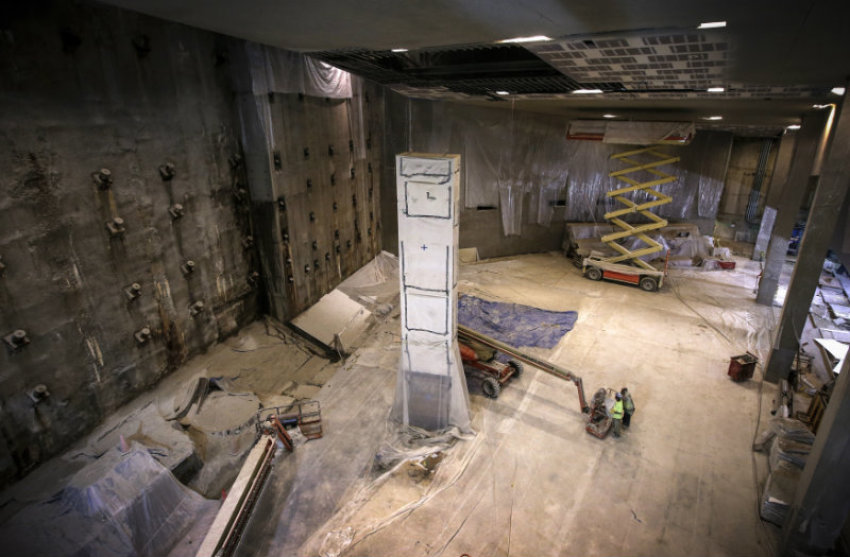 Construction continues around the last column of steel removed from the World Trade Center site in 2002, inside the 911 Memorial Museum, which is under construction, at the World Trade Center site in New York, July 2, 2013. The column (seen covered with protective material) is covered with messages and mementos of tribute affixed to its surfaces by recovery workers, first responders and family members of victims and will stand in this area of the Museum next to the 