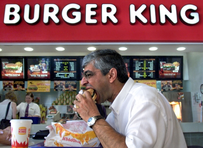 Benny Kashriel, mayor of the Maale Adumim West Bank Jewish settlement, bites into his Whopper burger as he eats lunch at the newly-opened Burger King in the town August 9. The Cairo-based Arab League threatened to stage a boycott of the US fast-food giant after it opened a new restaurant in this settlement which is built on land seized by Israel in the 1967 Middle East War.
