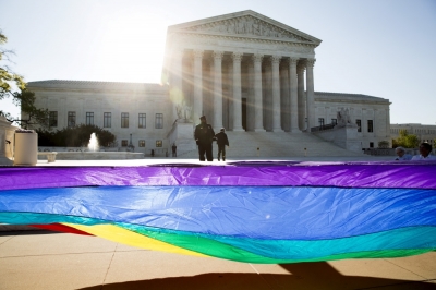 Gay marriage supporters hold a gay rights flag in front of the Supreme Court before a hearing about gay marriage in Washington, April 28, 2015. The nine justices will be hearing arguments concerning gay marriage restrictions imposed in Kentucky, Michigan, Ohio and Tennessee, four of the 13 states that still outlaw such marriages.