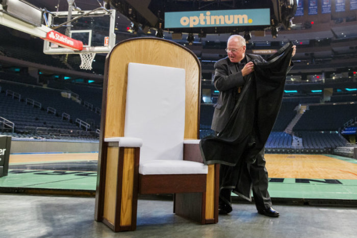 Archbishop of New York Cardinal Timothy M. Dolan unveils a chair that will be used in Madison Square Garden for Pope Francis' upcoming Papal Mass in New York Sept. 2, 2015.